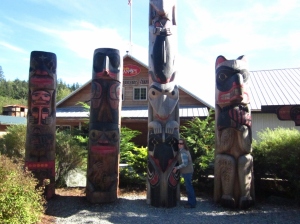 P. Rickrode and totems. Ketchikan, Alaska. Photo by C. Rickrode 2014.