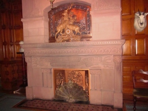 The main hall fireplace inspribed with this phrase from Shakespear's Troilus and Cressida, "Welcome ever smiles and farewell goes out sighing." Craigdarroch Castle, Victoria BC. Photo by P. Rickrode September 2014.