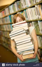 woman carrying stack of books